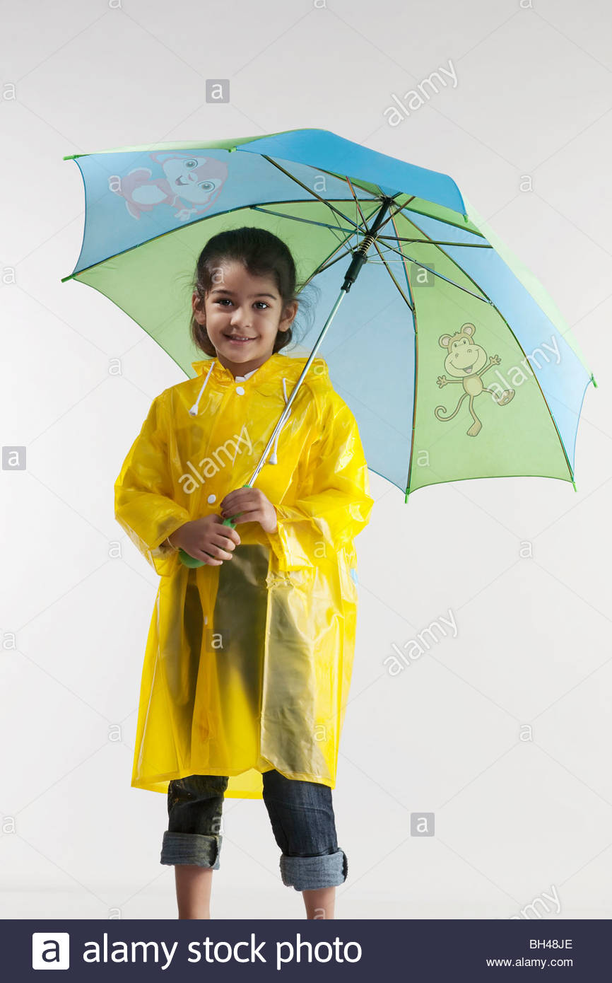 girl-wearing-a-raincoat-and-holding-an-umbrella-BH48JE.jpg