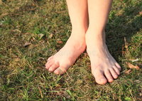 bare-feet-grass-little-kid-girl-standing-meadow-52621791.jpg